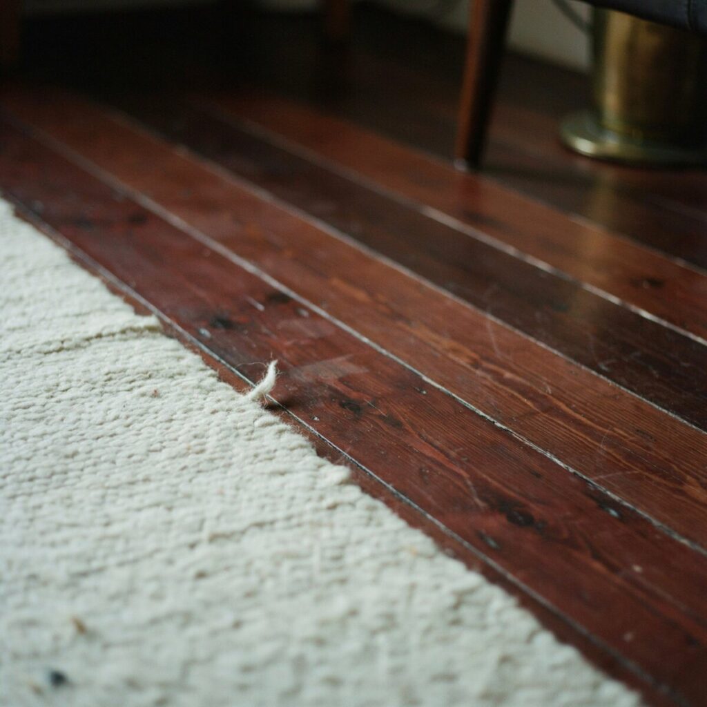 Dark Wood Floors with Pale Area Rugs for Contrast