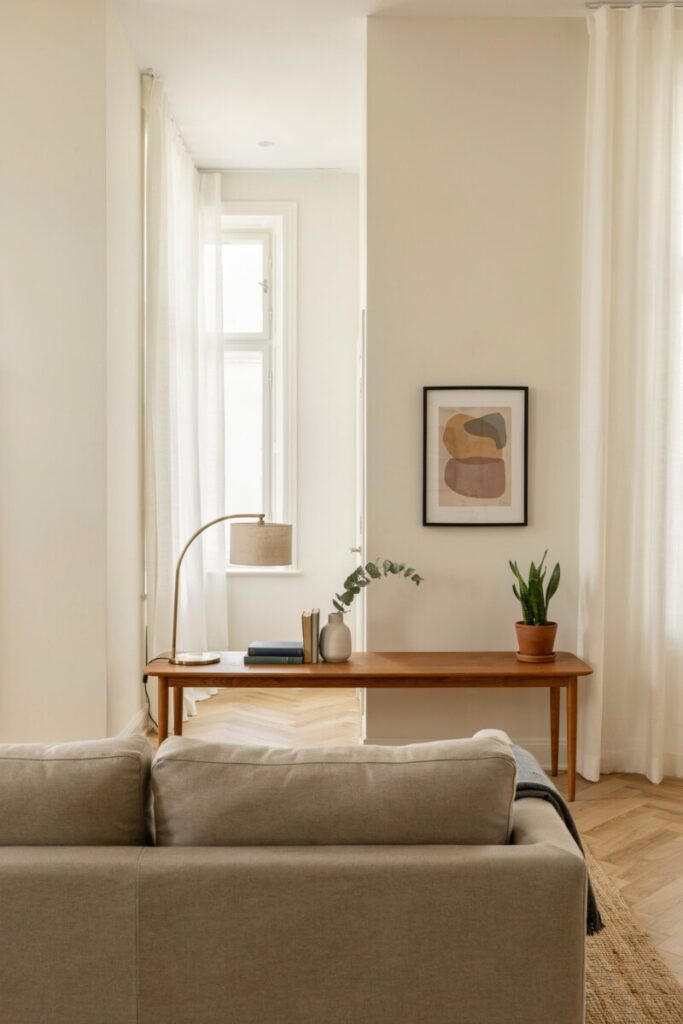 Floating furniture in a long narrow living room with a console table behind the sofa to improve traffic flow.